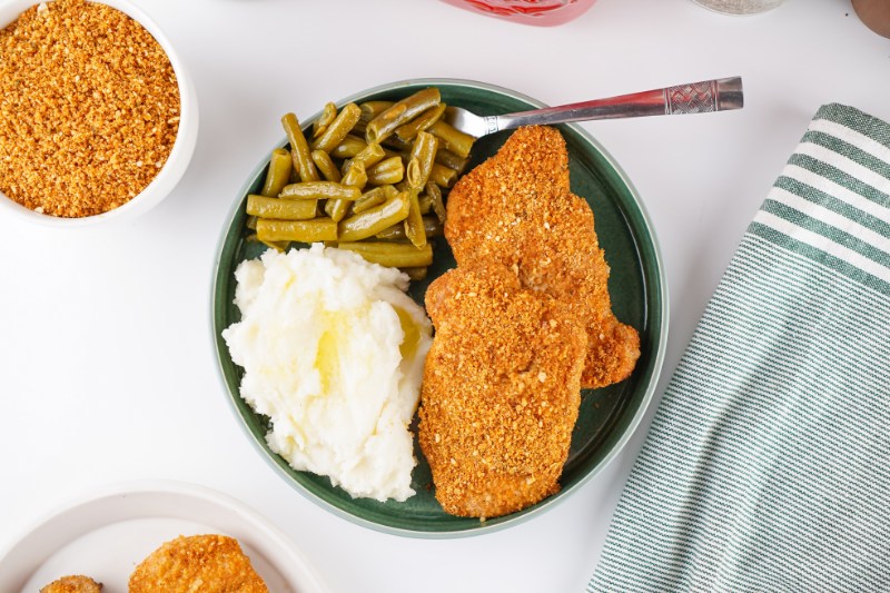 meal on a plate with chicken coated in homemade shake and bake
