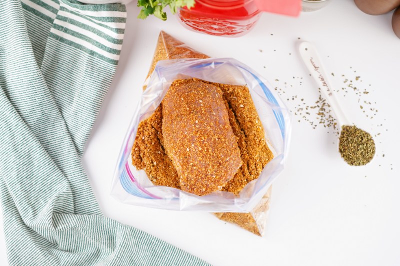 coating chicken in homemade shake and bake