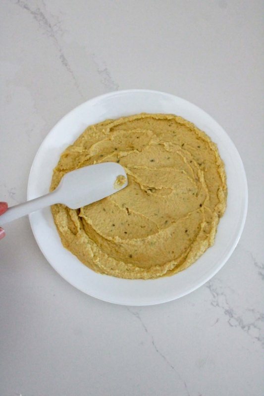 Smoothing out Hummus in Bowl