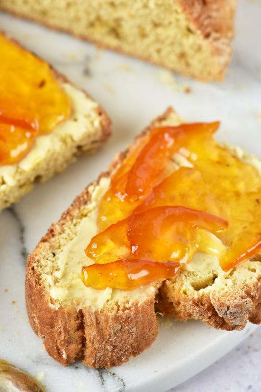 close up of jelly on a slice with butter