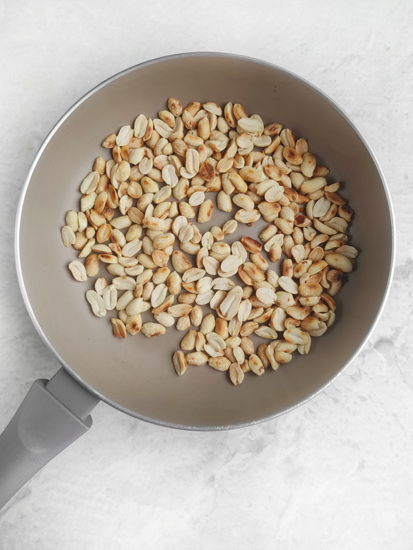Toasting the peanuts in a pan