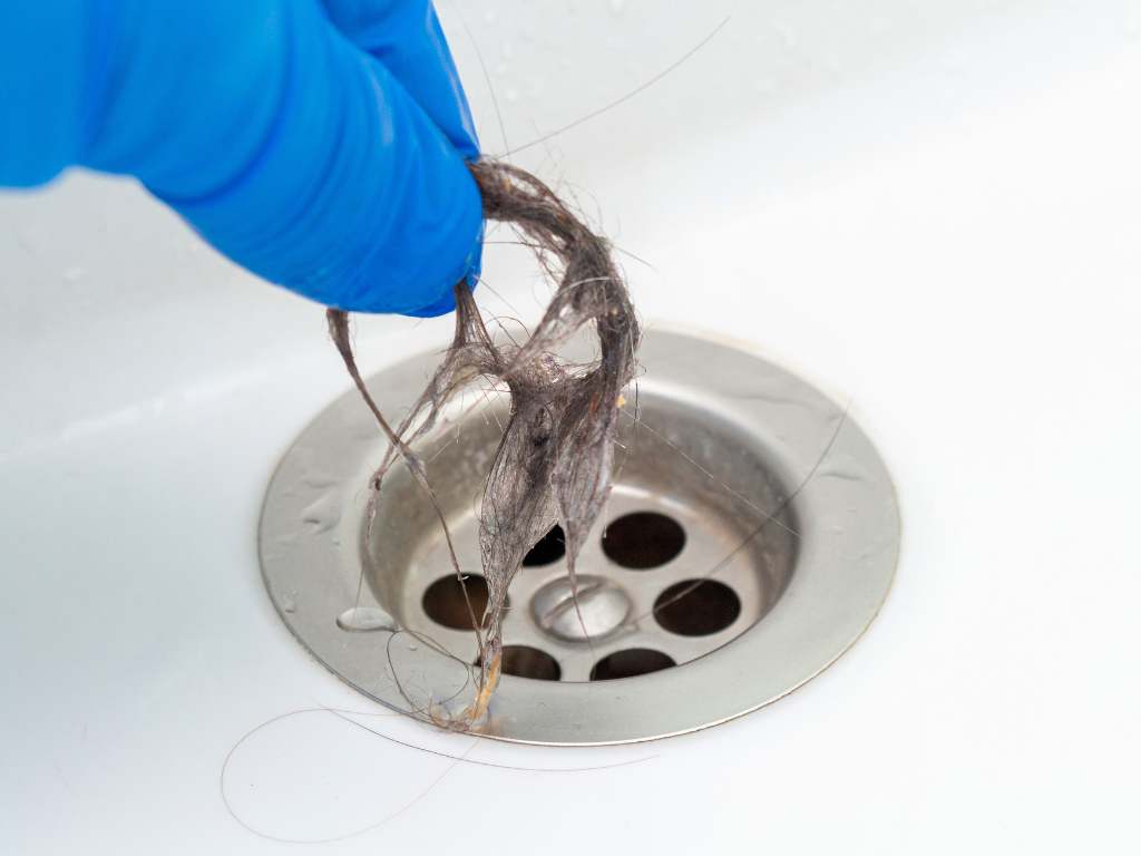Clean a bathtub drain when hair is clogging drain