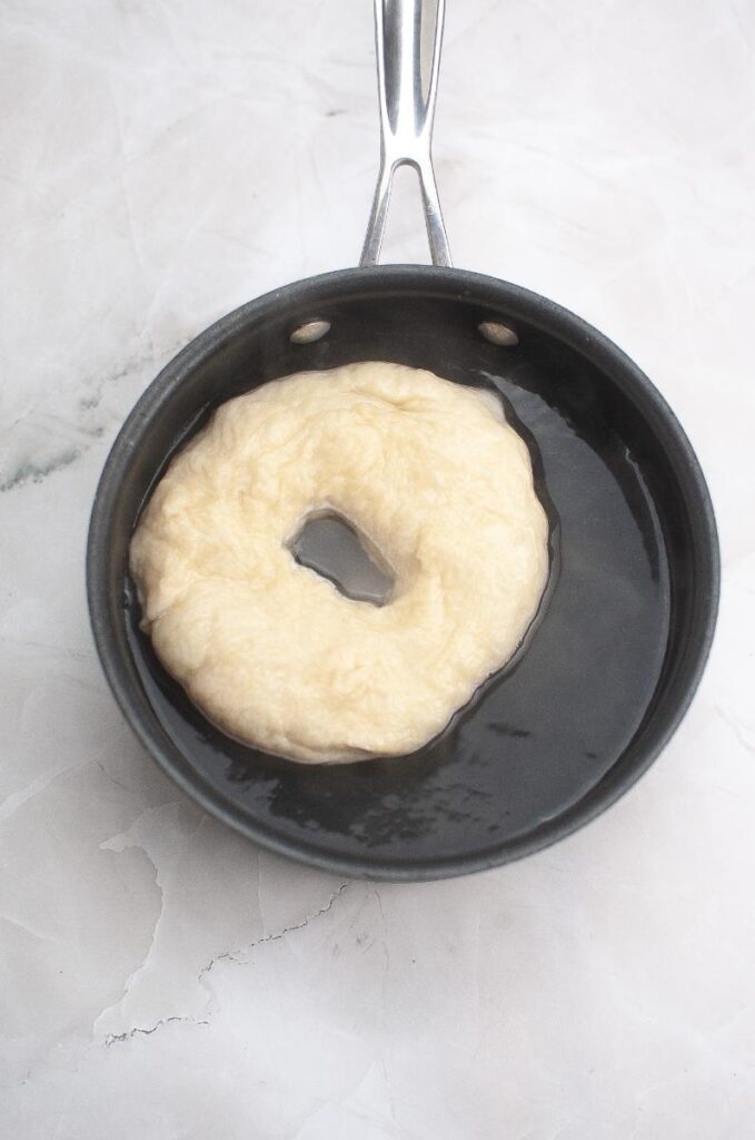 Homemade Sourdough Bagels in waterbath