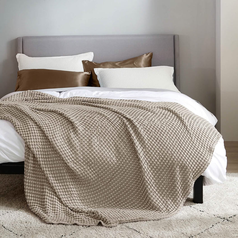 Taupe Bedsure waffle blanket draped over a white bed Non-Toxic Bedroom Swaps